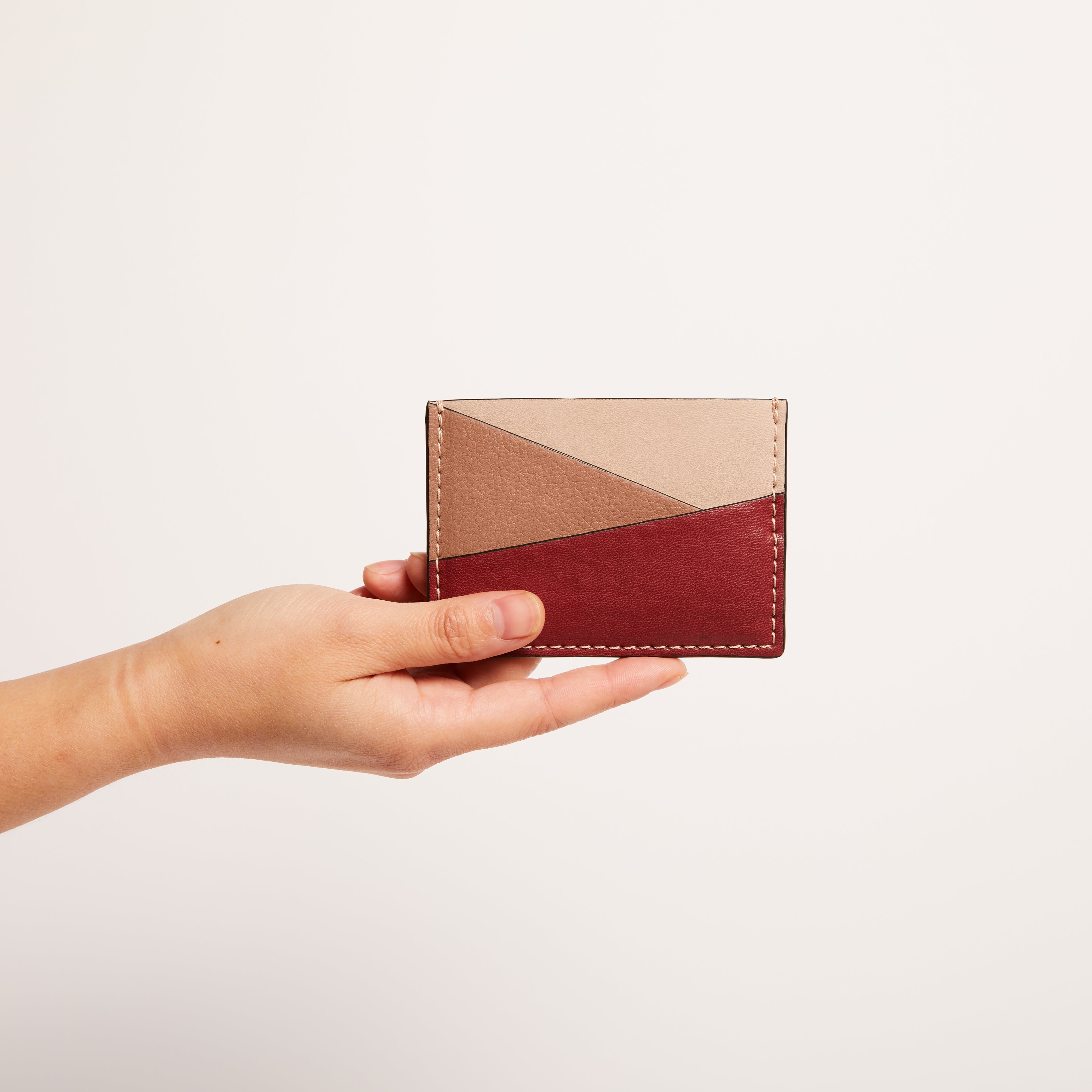 a hand holding gala puzzle cardholder 